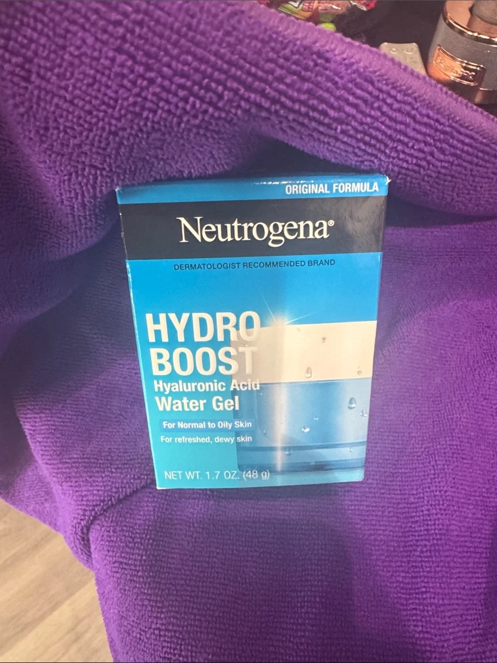 Neutrogena Hydro Boost Water Gel in blue packaging with purple backdrop